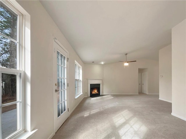 unfurnished living room featuring ceiling fan and light carpet