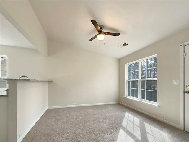 unfurnished room with carpet and ceiling fan