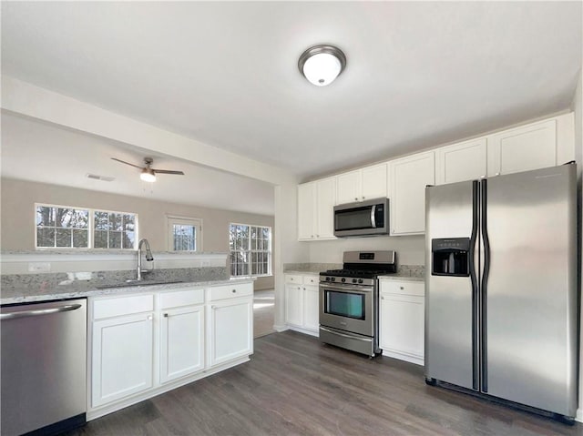 kitchen featuring white cabinets, appliances with stainless steel finishes, and sink