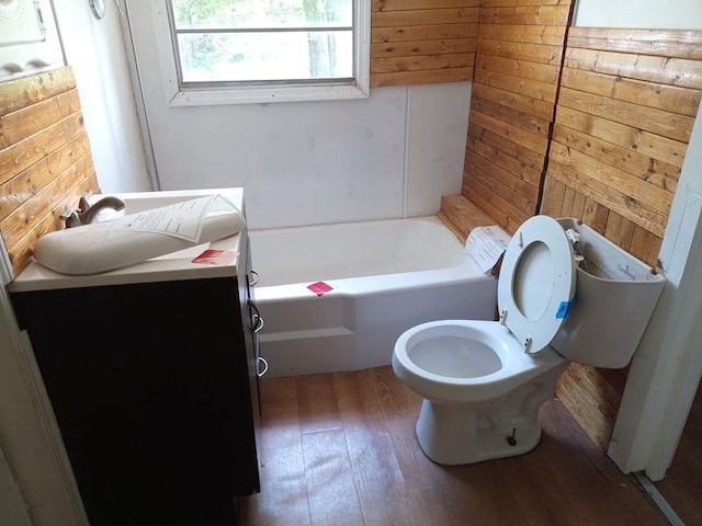 2205 Buchanan Hwy, Cedartown, GA 30125 - bathroom with wood walls, wood finished floors, toilet, a bathtub, and vanity
