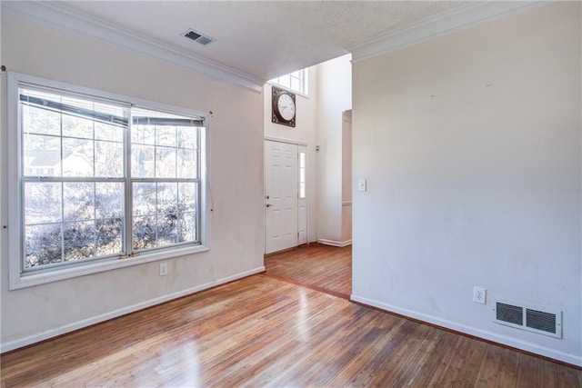 entryway featuring hardwood / wood-style flooring and ornamental molding