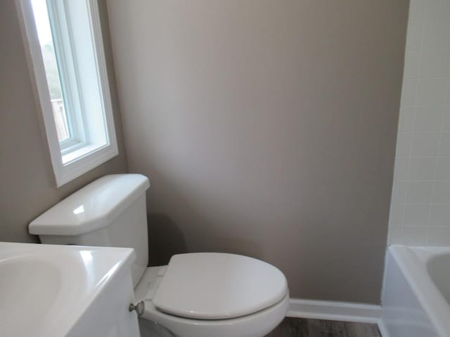 bathroom featuring a bathing tub and toilet