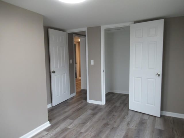 unfurnished bedroom with a closet and light wood-type flooring