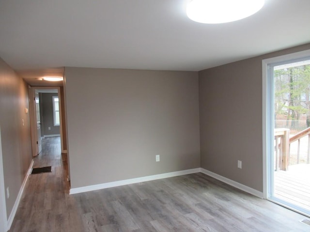 unfurnished room with hardwood / wood-style flooring