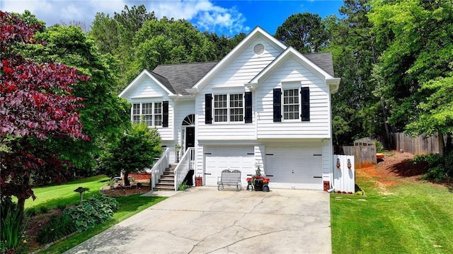 4184 Wyndham Park Way, Buford, GA 30519 - raised ranch with a garage, concrete driveway, and stairway