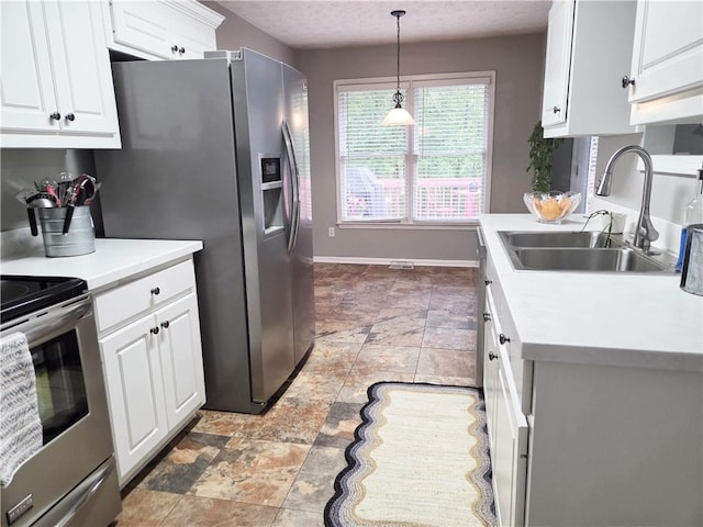 4184 Wyndham Park Way, Buford, GA 30519 - kitchen featuring a sink, appliances with stainless steel finishes, light countertops, white cabinetry, and light stone finish flooring