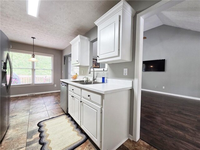 4184 Wyndham Park Way, Buford, GA 30519 - kitchen featuring a sink, appliances with stainless steel finishes, white cabinets, a textured ceiling, and light countertops
