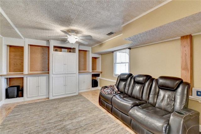 living area featuring ornamental molding, visible vents, and ceiling fan