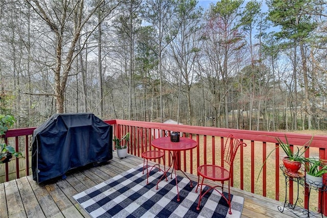 wooden terrace featuring a grill