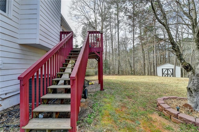 view of yard with stairs, a storage unit, a deck, and an outbuilding