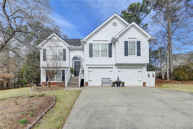 raised ranch with an attached garage and concrete driveway