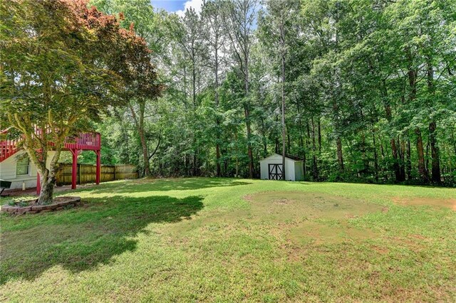 4184 Wyndham Park Way, Buford, GA 30519 - view of yard featuring a shed, an outdoor structure, and a wooden deck