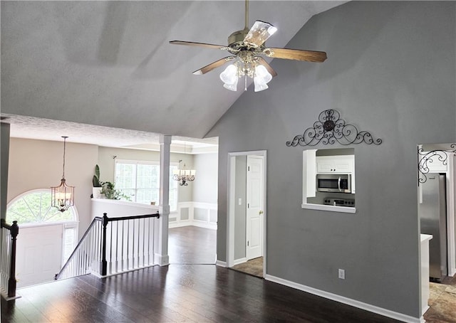 4184 Wyndham Park Way, Buford, GA 30519 - empty room with a chandelier, high vaulted ceiling, wood finished floors, ceiling fan, and baseboards