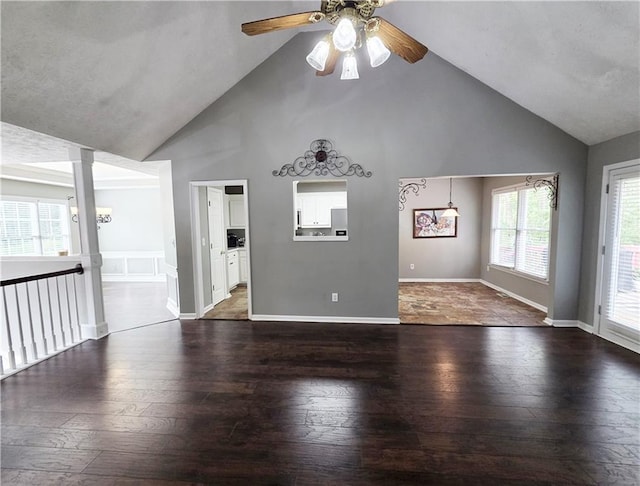 4184 Wyndham Park Way, Buford, GA 30519 - unfurnished living room with high vaulted ceiling, a ceiling fan, dark wood-style flooring, decorative columns, and baseboards