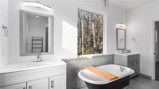 bathroom with a bath, tile patterned floors, breakfast area, and vanity