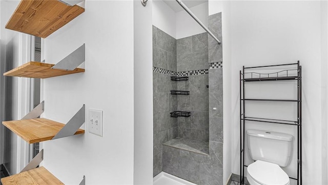 bathroom with tiled shower and toilet