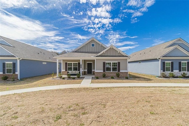 craftsman-style house with a front yard and covered porch