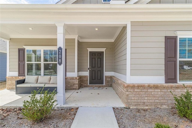 doorway to property featuring covered porch