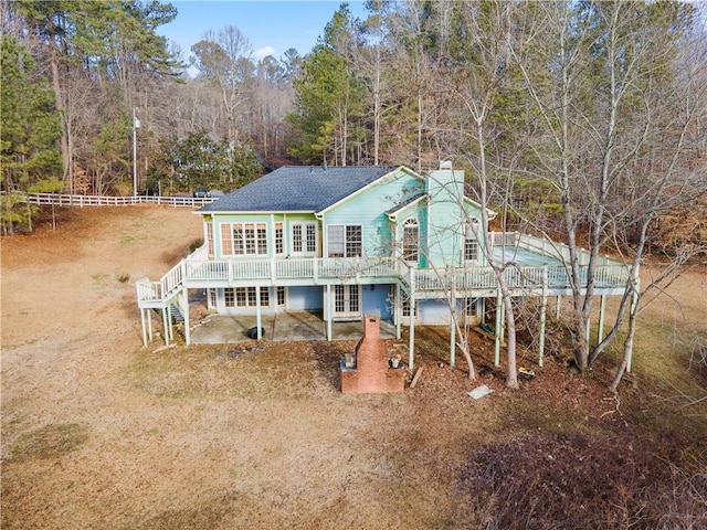 rear view of property featuring french doors, stairway, fence, a wooden deck, and a patio area