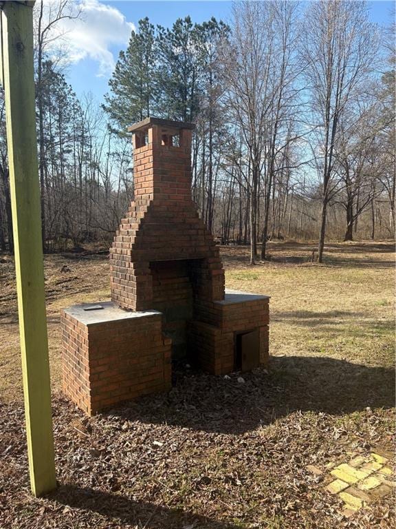 view of yard with a fireplace