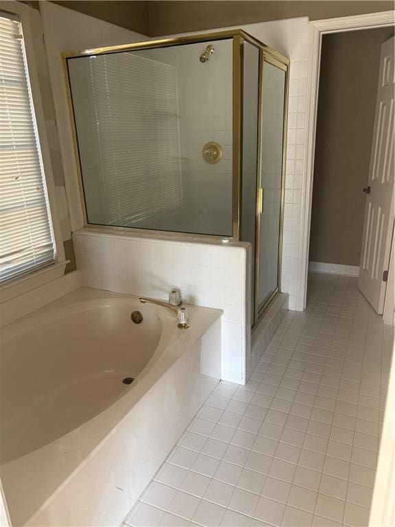 full bath with tile patterned flooring, a garden tub, and a shower stall