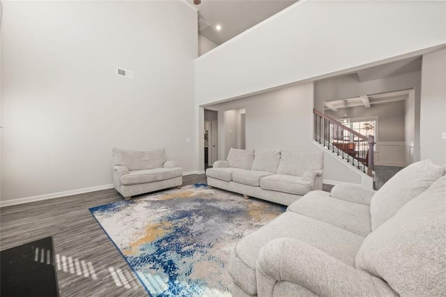 living room featuring hardwood / wood-style flooring and high vaulted ceiling