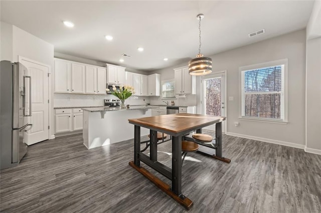 dining space with dark hardwood / wood-style floors and a notable chandelier