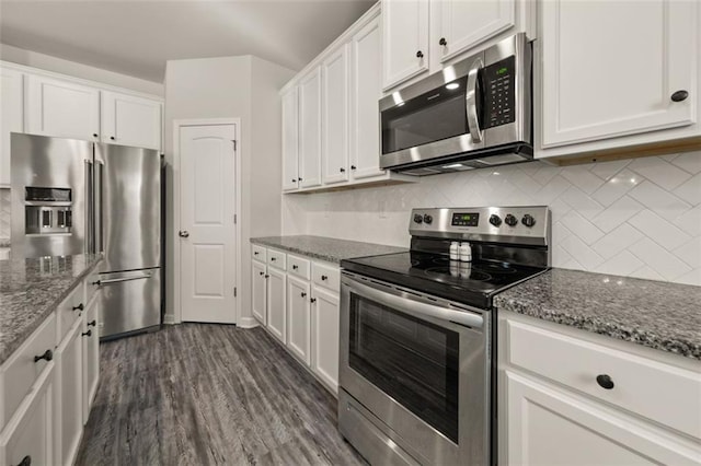 kitchen featuring dark hardwood / wood-style flooring, white cabinets, stone countertops, and appliances with stainless steel finishes