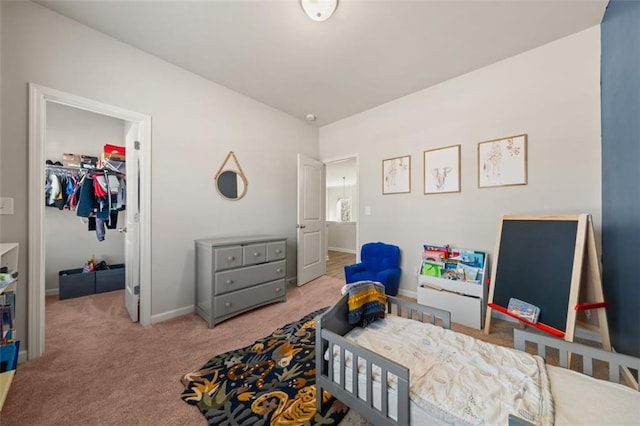 bedroom featuring carpet floors, a spacious closet, and a closet