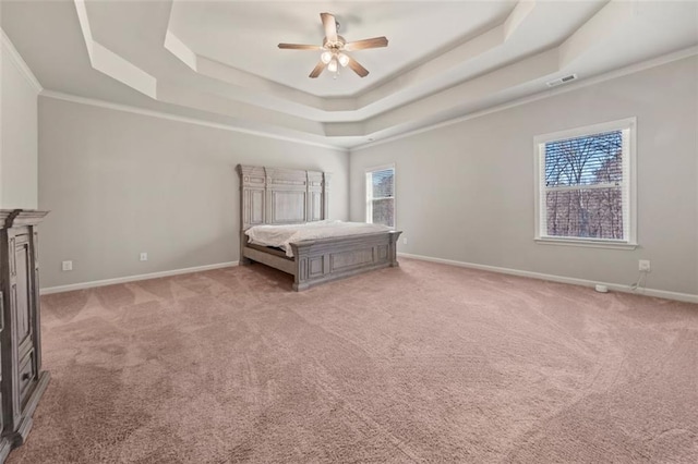 unfurnished bedroom featuring ceiling fan, light colored carpet, and a tray ceiling