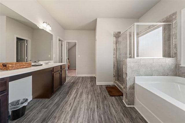 bathroom featuring separate shower and tub, vanity, and hardwood / wood-style flooring