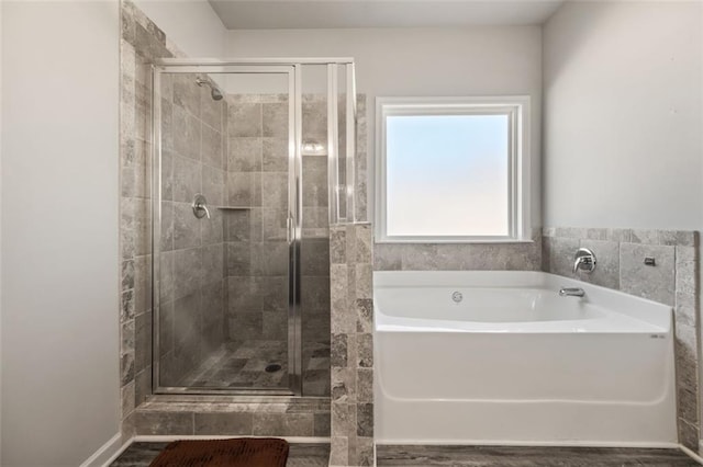 bathroom featuring separate shower and tub