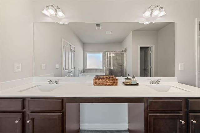 bathroom featuring vanity, independent shower and bath, and a chandelier