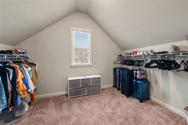 spacious closet with light carpet and vaulted ceiling