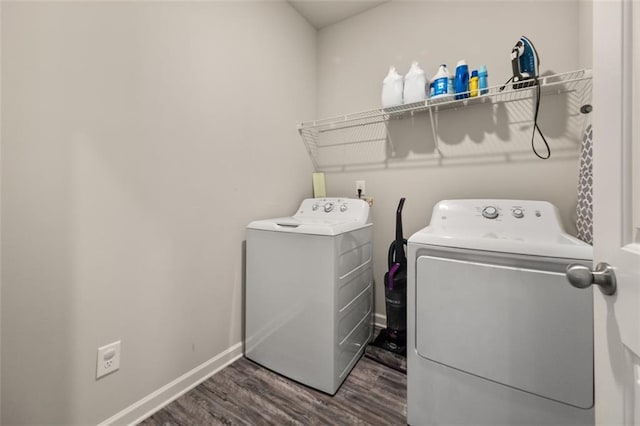 washroom with dark hardwood / wood-style flooring and independent washer and dryer