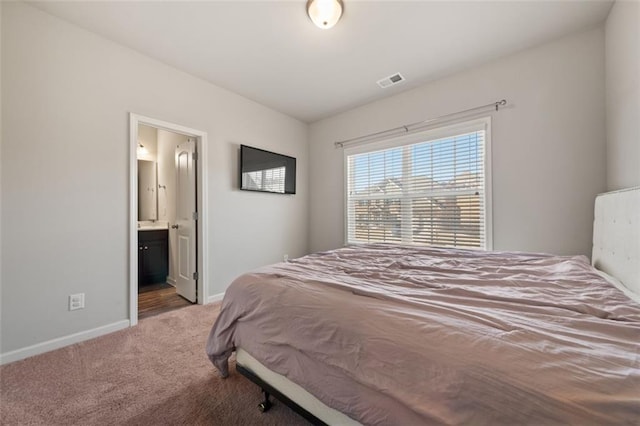 carpeted bedroom with ensuite bath