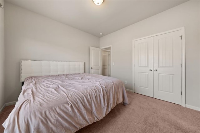 bedroom with light carpet and a closet