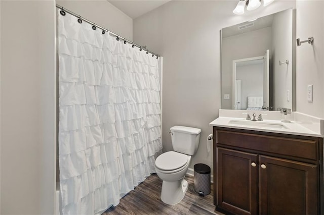 bathroom featuring a shower with shower curtain, vanity, hardwood / wood-style flooring, and toilet