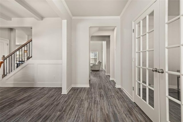 corridor with beamed ceiling, dark hardwood / wood-style flooring, crown molding, and french doors