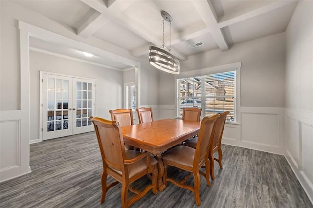 dining room featuring beam ceiling, french doors, dark wood-type flooring, coffered ceiling, and a chandelier