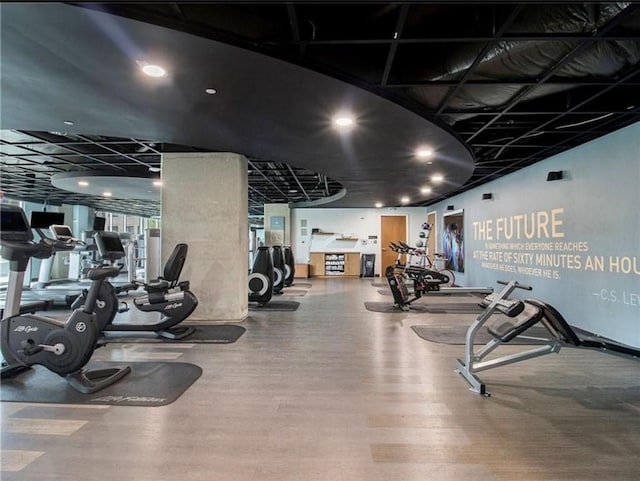 exercise room with hardwood / wood-style floors