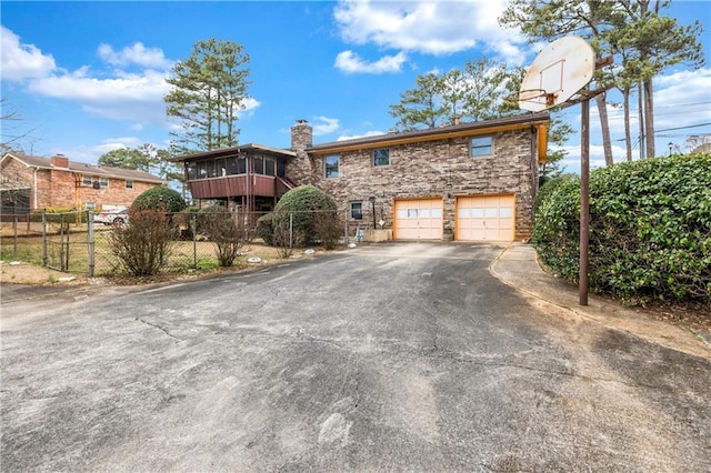 front of property featuring a garage and a sunroom