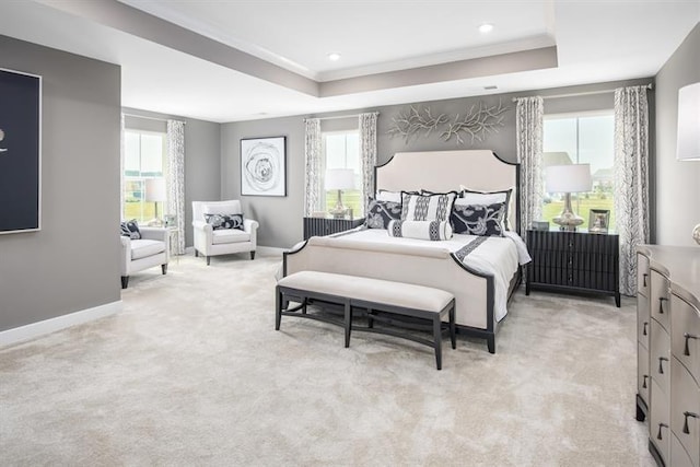 bedroom with crown molding, baseboards, light colored carpet, recessed lighting, and a raised ceiling