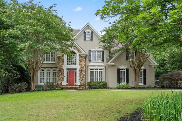 4575 Dairy Way, Peachtree Corners, GA 30092 - traditional-style house with stucco siding, stone siding, and a front lawn