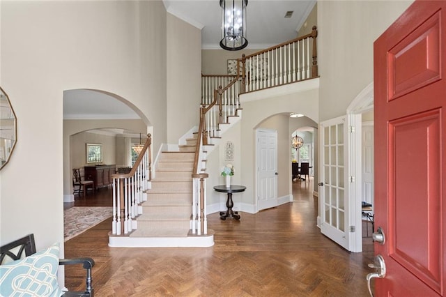 4575 Dairy Way, Peachtree Corners, GA 30092 - foyer with arched walkways, a high ceiling, stairs, baseboards, and crown molding