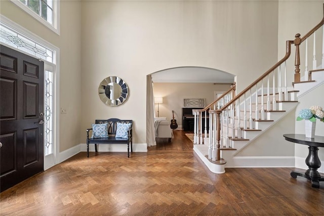 4575 Dairy Way, Peachtree Corners, GA 30092 - entrance foyer with arched walkways, a high ceiling, stairs, and baseboards