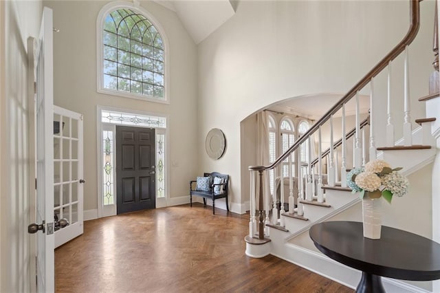 4575 Dairy Way, Peachtree Corners, GA 30092 - entryway with arched walkways, a towering ceiling, stairway, and baseboards