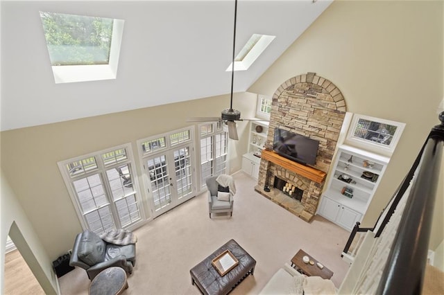 4575 Dairy Way, Peachtree Corners, GA 30092 - carpeted living area featuring a skylight, a fireplace, high vaulted ceiling, plenty of natural light, and a ceiling fan