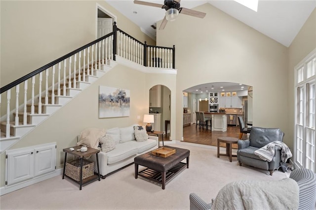 4575 Dairy Way, Peachtree Corners, GA 30092 - living area with arched walkways, high vaulted ceiling, ceiling fan, stairway, and light colored carpet