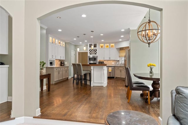 4575 Dairy Way, Peachtree Corners, GA 30092 - living area featuring recessed lighting, a chandelier, dark wood-style floors, arched walkways, and crown molding